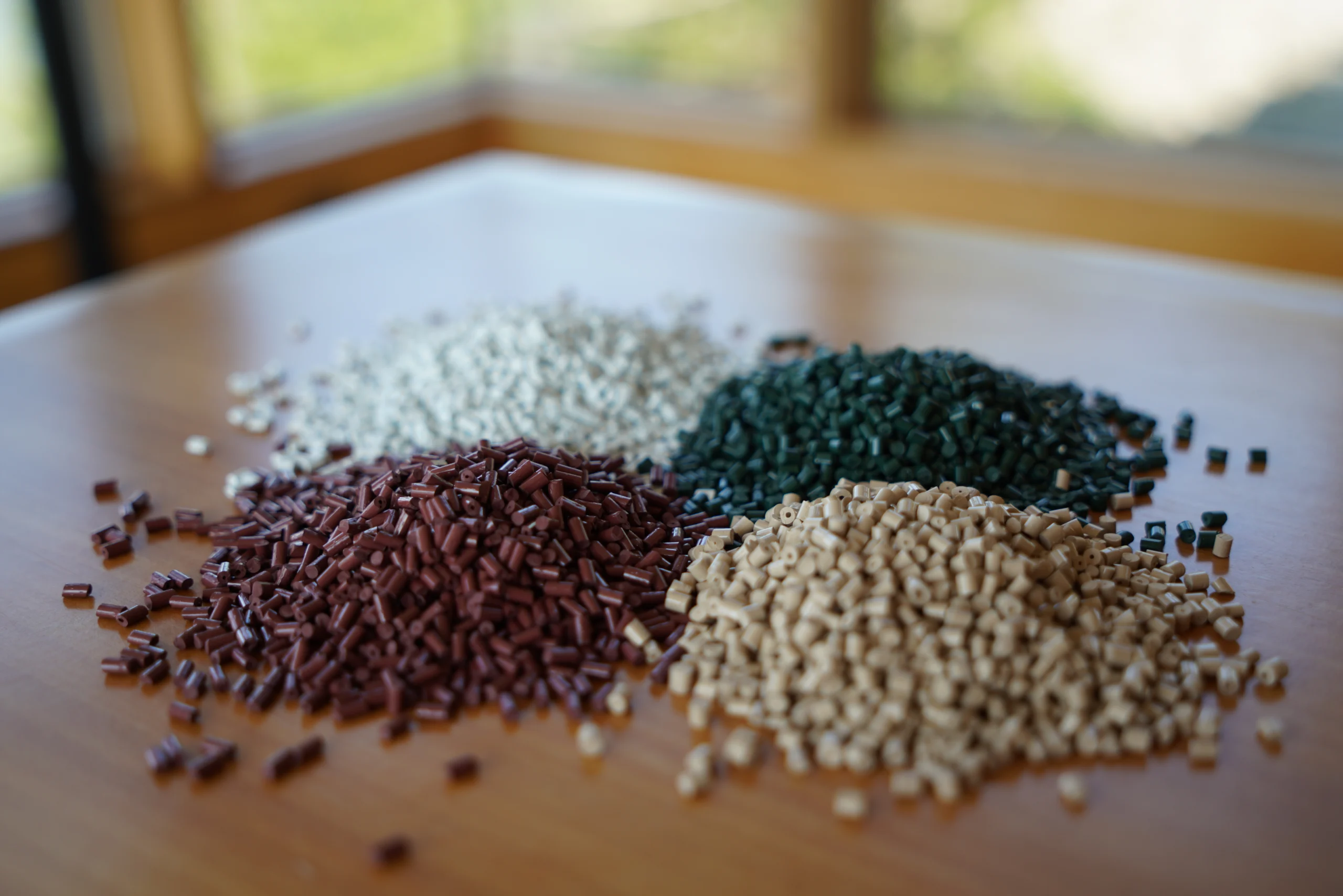 Piles of custom-colored polymer compound pellets